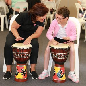 Chorus staff drumming with customer