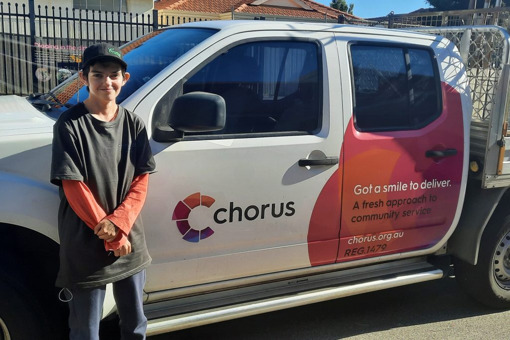 Hannah standing by a Chorus gardening vehicle