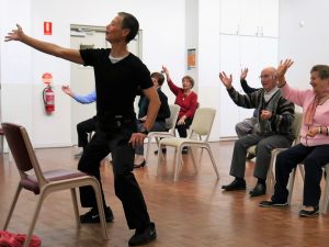 Volunteer Michael leading Tai Chi for seniors