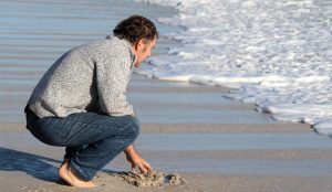 A man on the beach, symbolising mens mental health