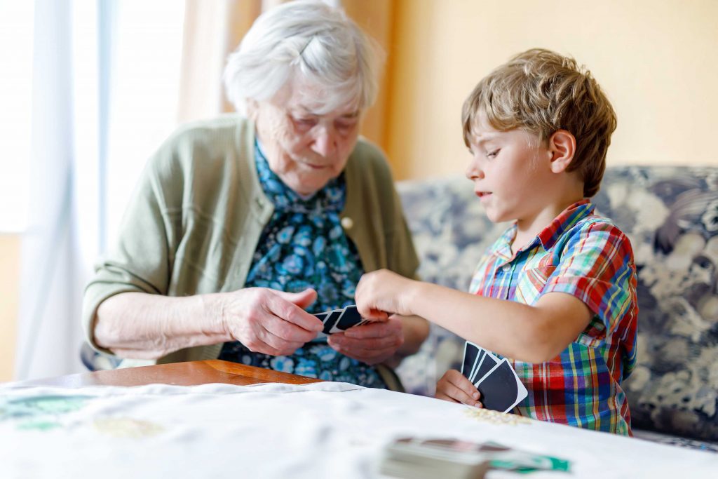 Grandmother playing cards with grandson