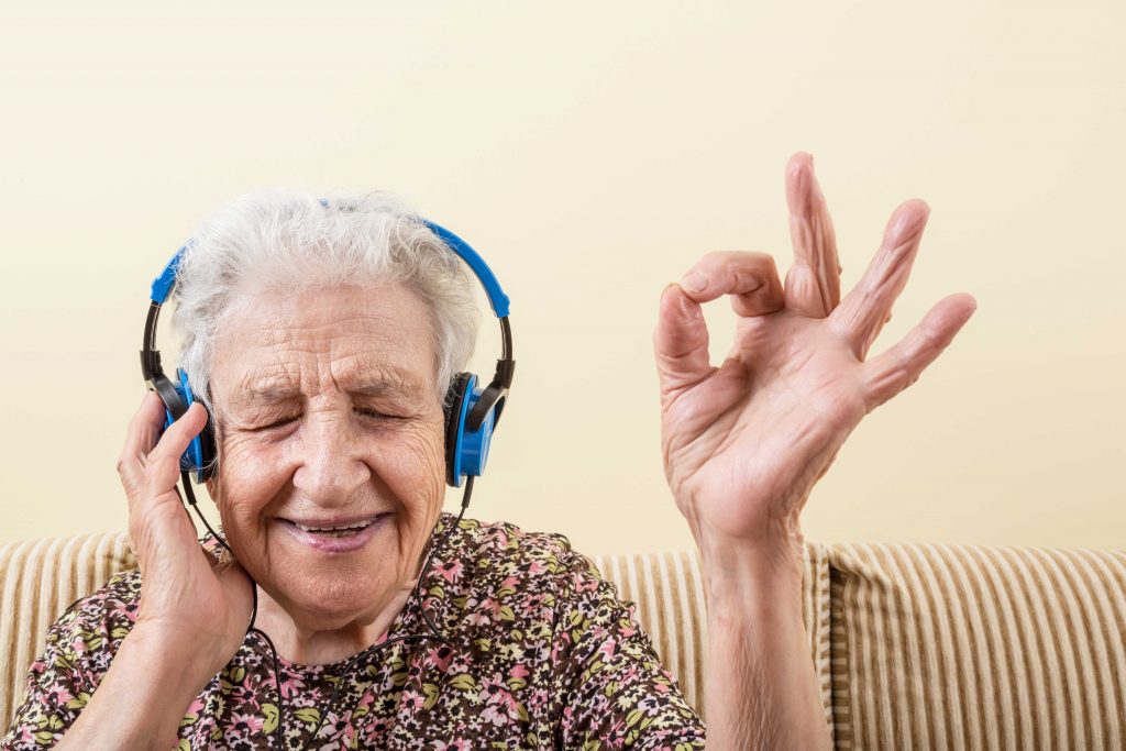 older woman enjoying hearing music