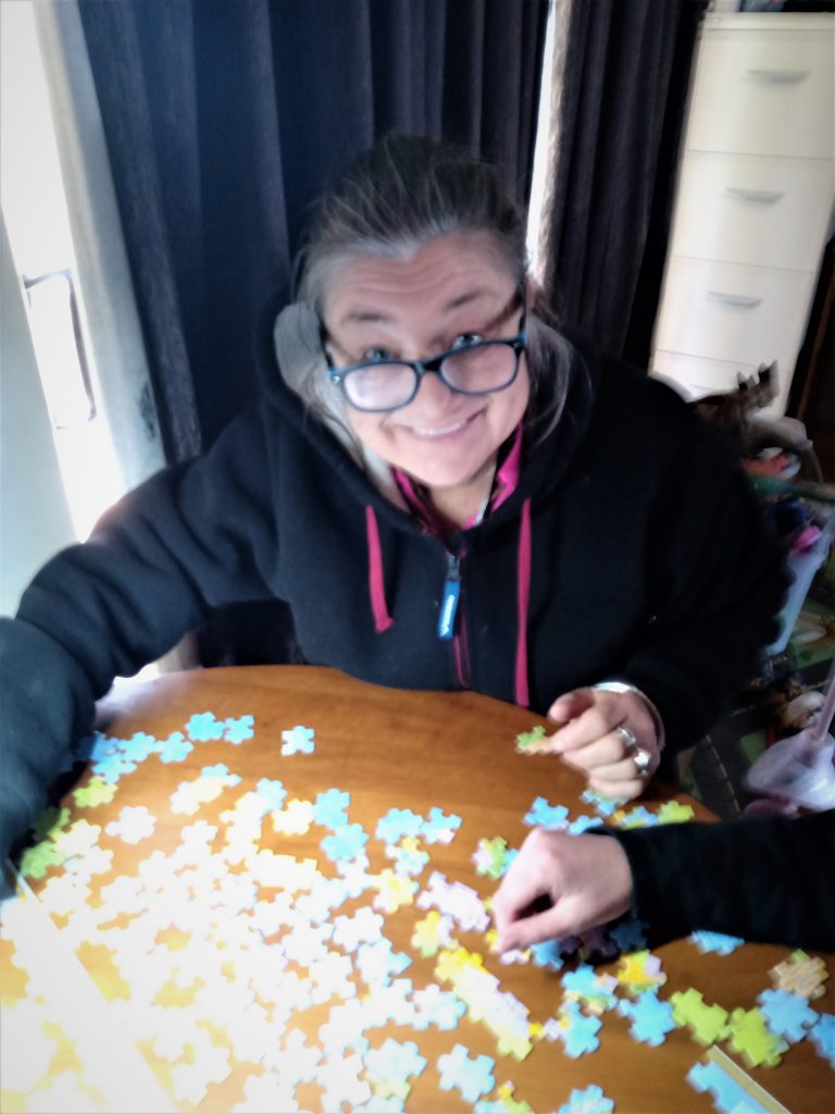 Mandy works on a puzzle with Helen